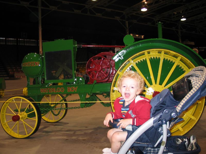 William with Waterloo Boy
William poses excitedly with a beautifully-resored Waterloo Boy tractor.  The Waterloo Boy was the first tractor sold by Deere, and is the reason that most Deere tractors are still produced in Waterloo, Iowa.
