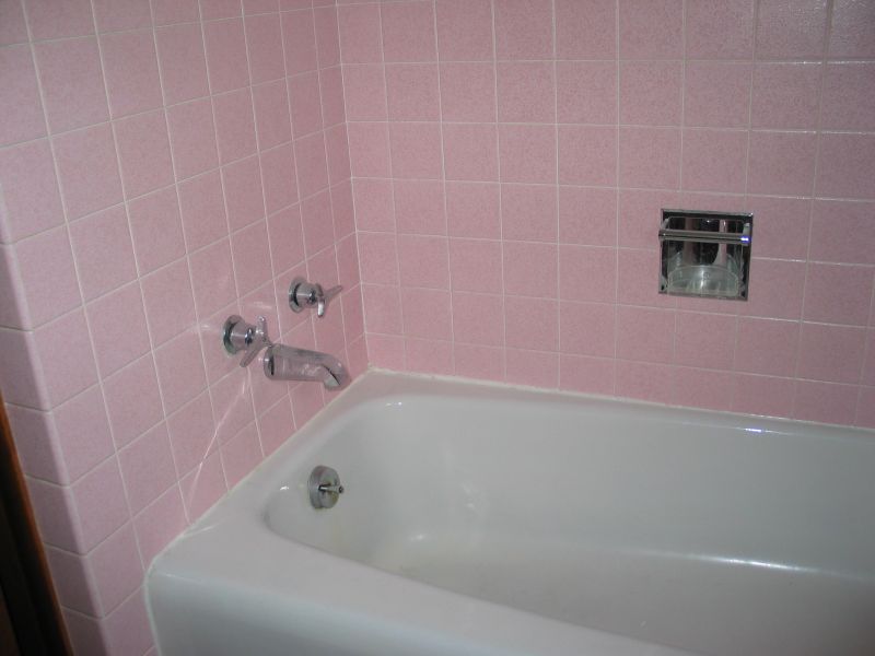 "Before" picture:  Tub area
Here's the original tub area.  No shower, and lots more pink!
