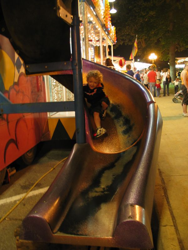 Funhouse Slide
After the fireworks, William was still pumped to go on more rides.  And we still had some more tickets, so we let him.  Here he comes down the slide at the end of the Fun House...
