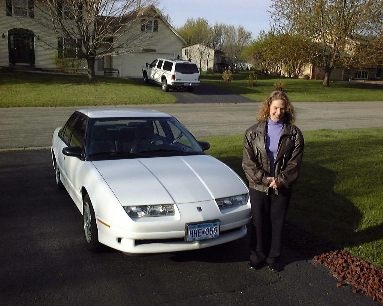 Cathy's old Saturn
We sold our Saturn in May, 2003.  This was originally Cathy's car before we were married, so she posed with it on the morning it was sold.

