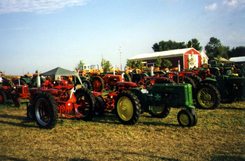 Tractors
Although John Deere is our favorite brand of farm equipment, there were many other brands at the show.  Some of them included Hart Parr, Oliver, Avery, International (FarmAll), Allis-Chalmers, Ford, White, Minneapolis-Moline, and more.  Here is a view of the yard.
