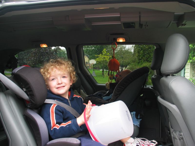 In the Van
William holds his bucket (which will be used for a craft) and gets ready to go to school.
