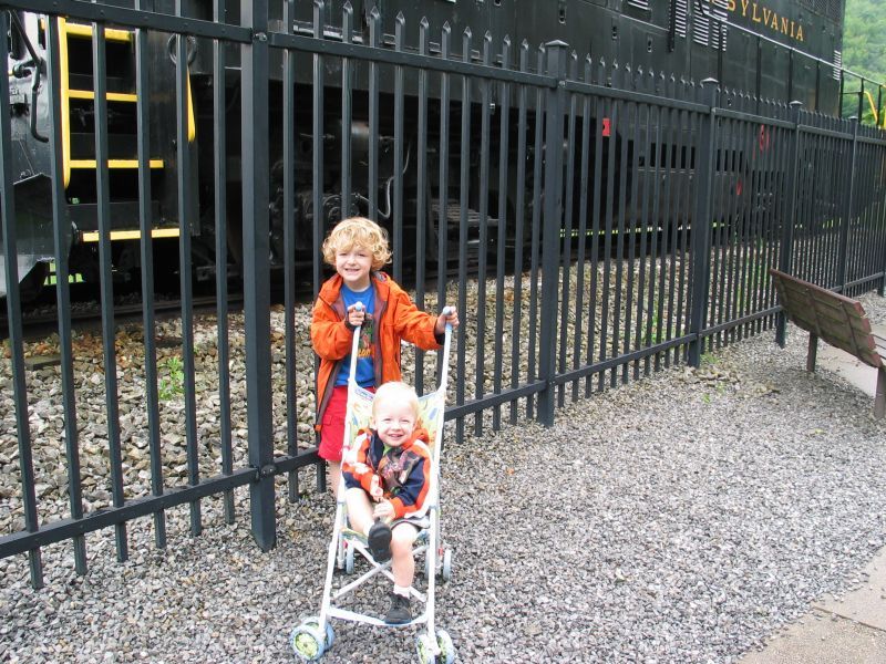 The boys poses by train

