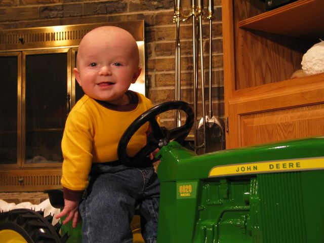 Dedication Picture
We posed William with his new John Deere pedal tractor for this shot which was shown during his dedication at church.  He couldn't quite sit up by himself, but it didn't take too long after this that he could.  He was not quite five months here.
