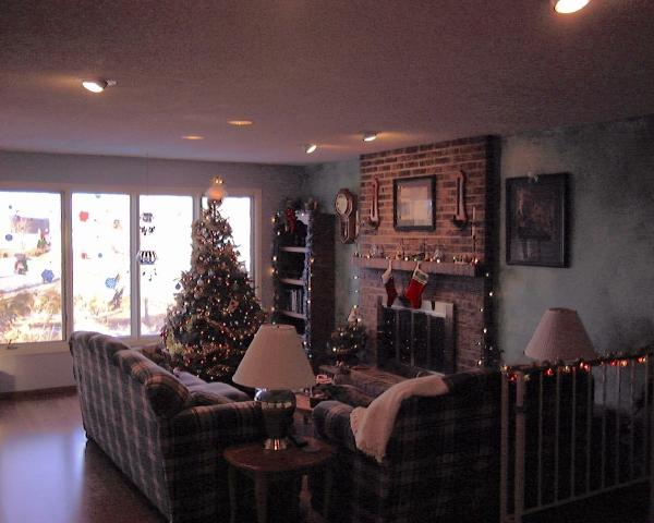 Living Room at Christmas
Here is a view of our living room taken Christmas 2002.  We really enjoy the fact that our home features two brick fireplaces (our previous home didn't have any).  The large windows overlook the back yard and pond.  We purchased new furniture for this room and completely painted and redecorated it.  

