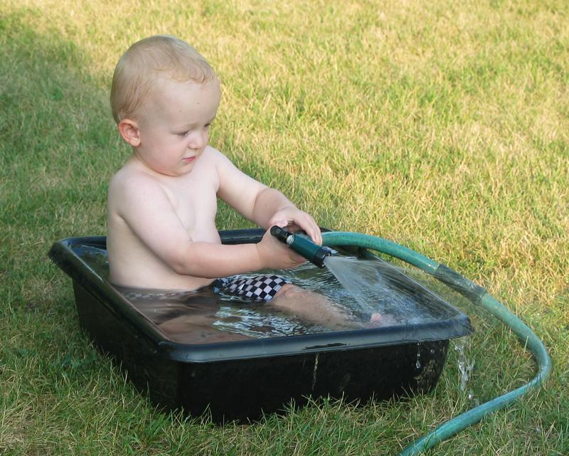 Loving the water
William loves water.  We really need to get him a little wading pool.  On this particular day, a black plastic tub made do in a pinch.
