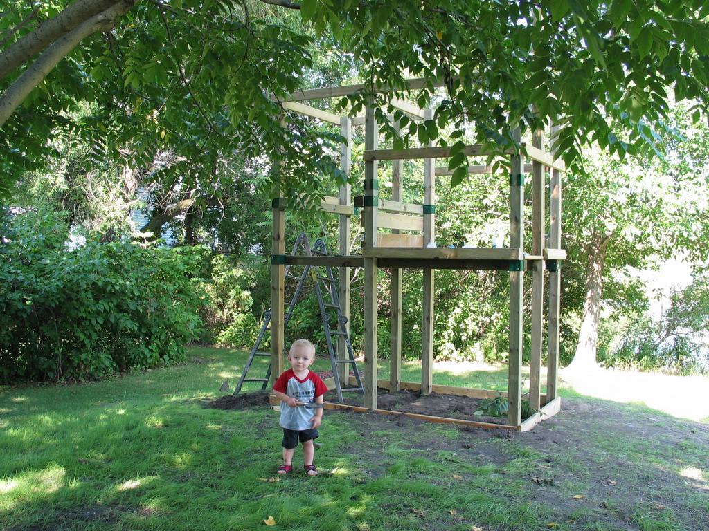 William checks out the situation
In the foreground, William poses with great anticipation of his new playground.  In the background, you can see the status at this point-- most of the lower deck is now complete, except for the "barrier boards" which make up the railings.
