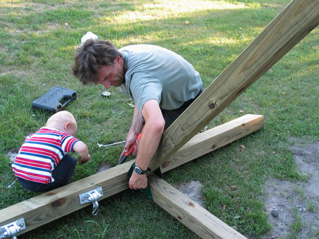 Attachment difficulties
Tim has a minor difficulty getting the bolts lined up with the T-nuts on top the swing beam.  William checked things out, offered his advice, and we were back on track.
