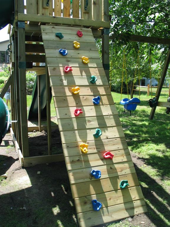 Rock Wall
On the back of the playground is the 7' rock wall.  After this picture was taken we added a knotted rope to aid in the climb.  William will have to grow into this one a bit.  
